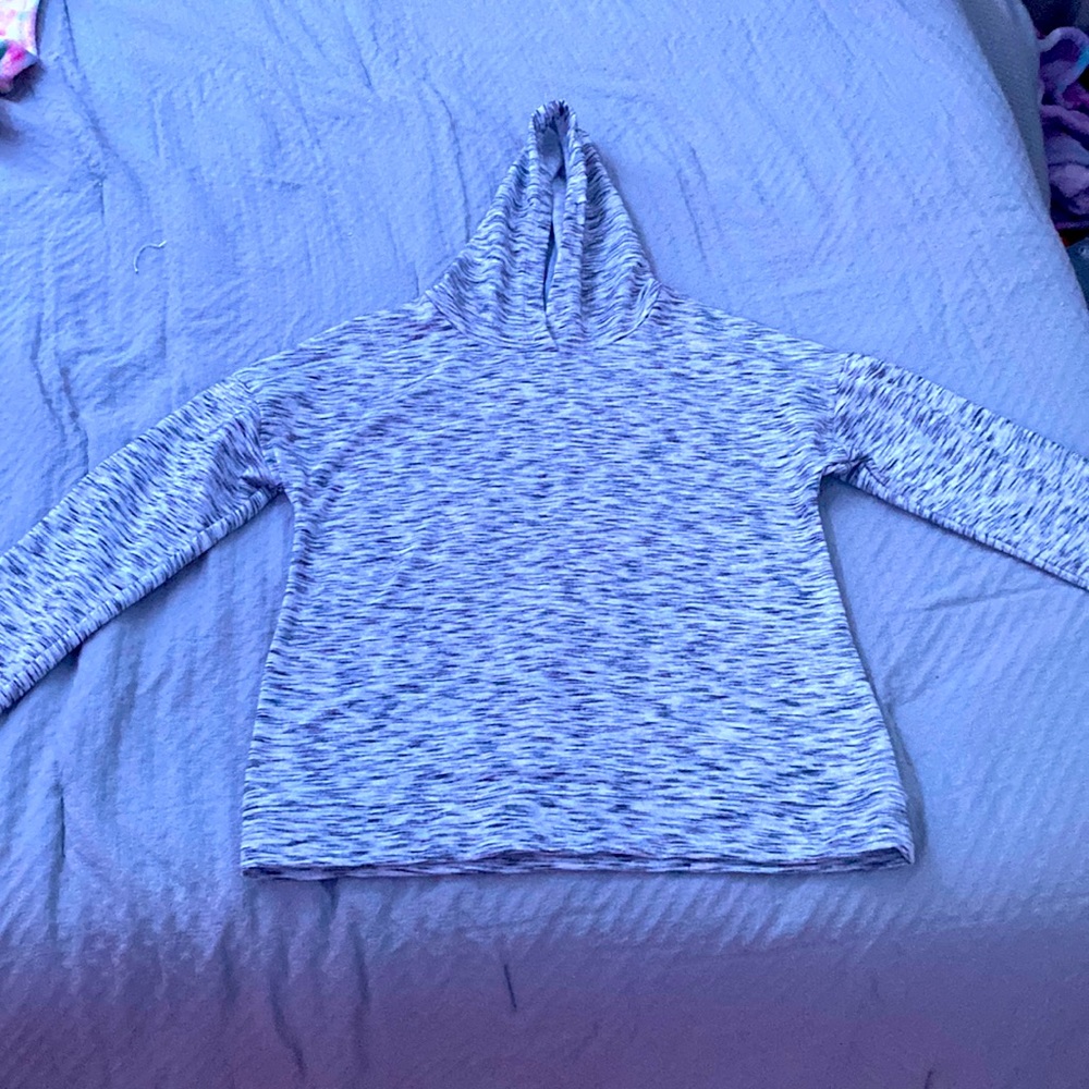 It’s grey white and black comfy and has a hood